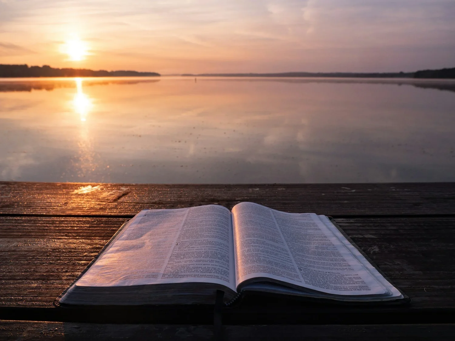 An open Bible at sunset