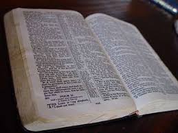 An open Bible illuminated by a beam of light
